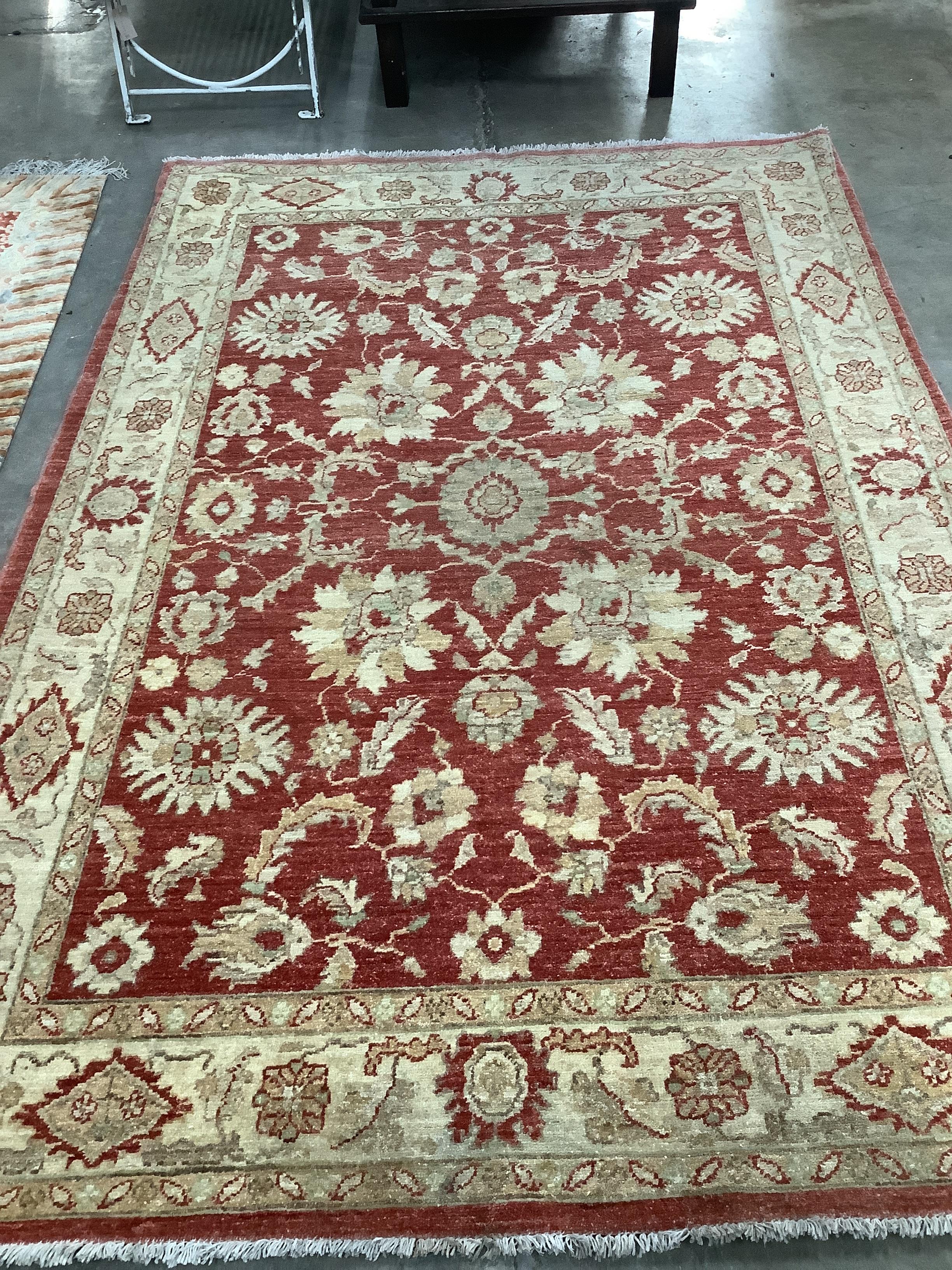 A Ziegler style burgundy ground rug, 220 x 150cm